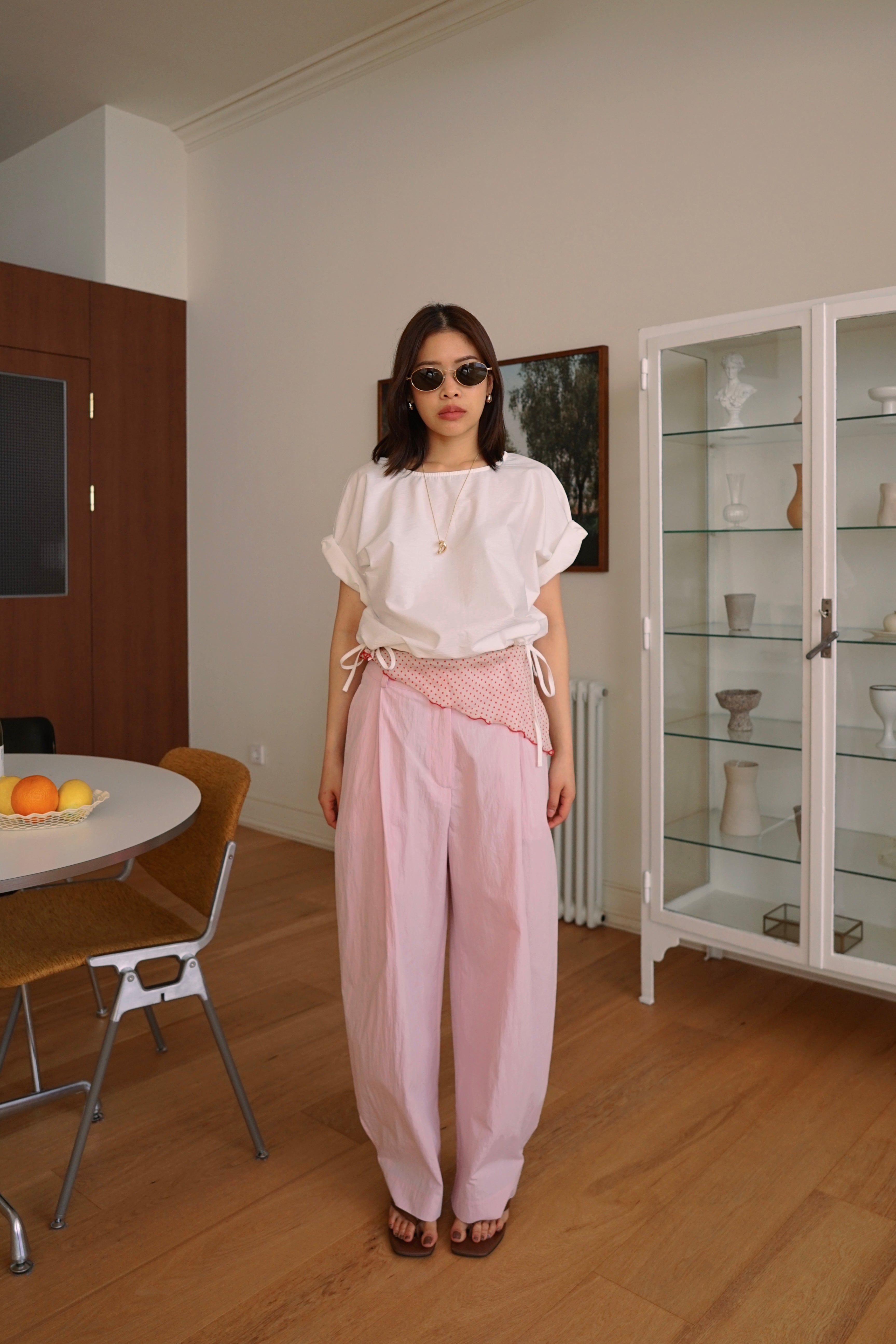 Pleated trousers with adjustable hem