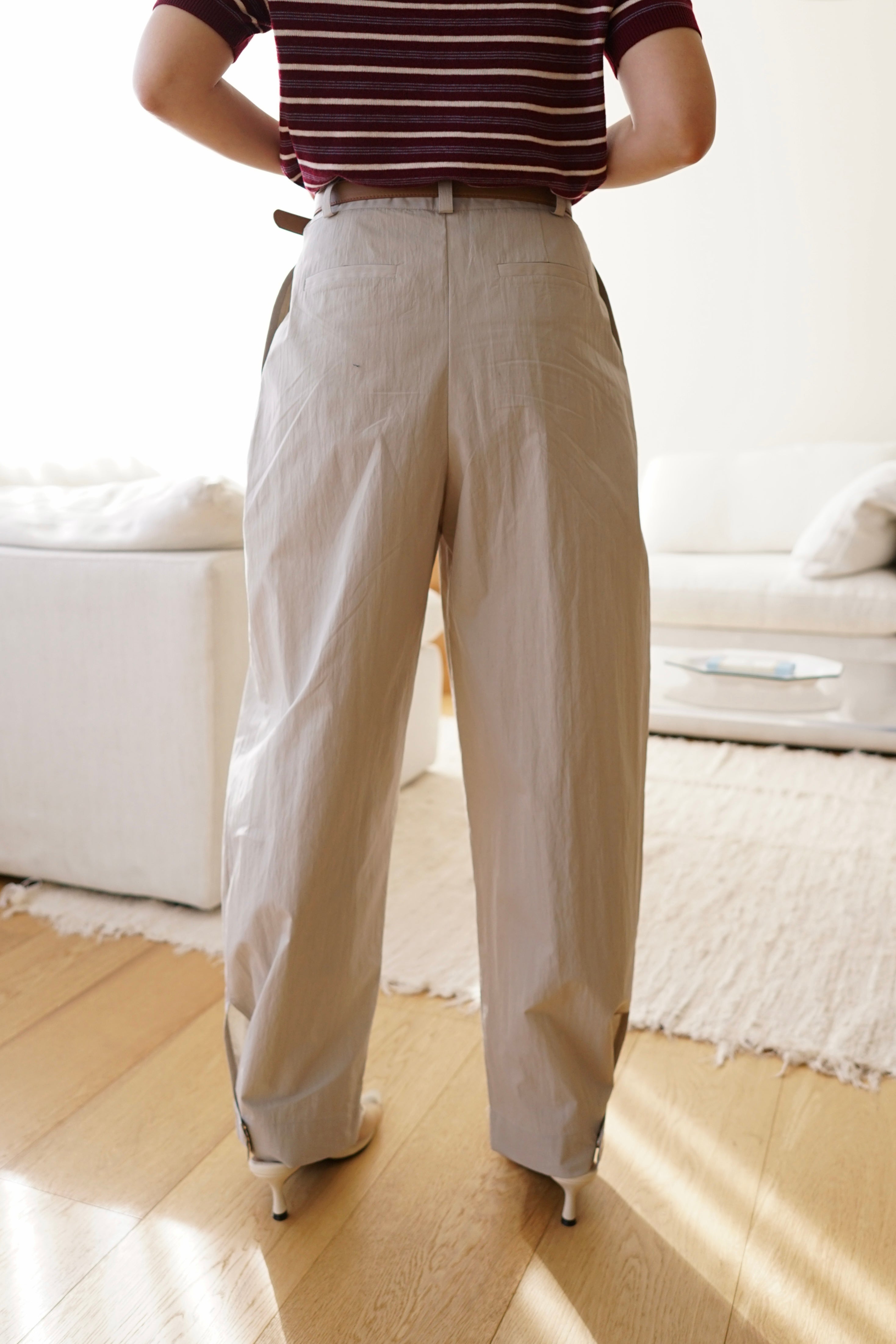 Pleated trousers with adjustable hem